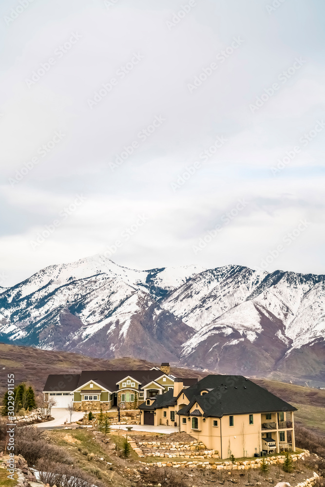 Residential area on a hill with luxury homes overlooking a snow capped mountain