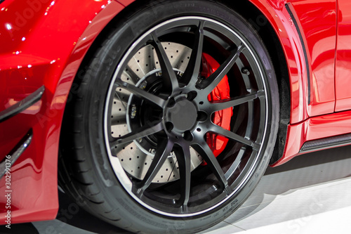 Red Brake Calipers On Red Car With Black Rims