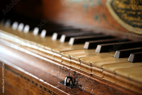 Close up shallow focus shot of a vintage piano or harpsichord keyboard, made of ebony, ivory and hardwood