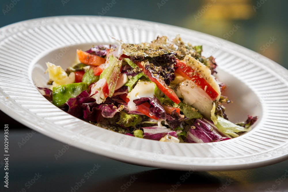 Fresh vegetable salad on a white plate Fresh vegetable salad on a white plate