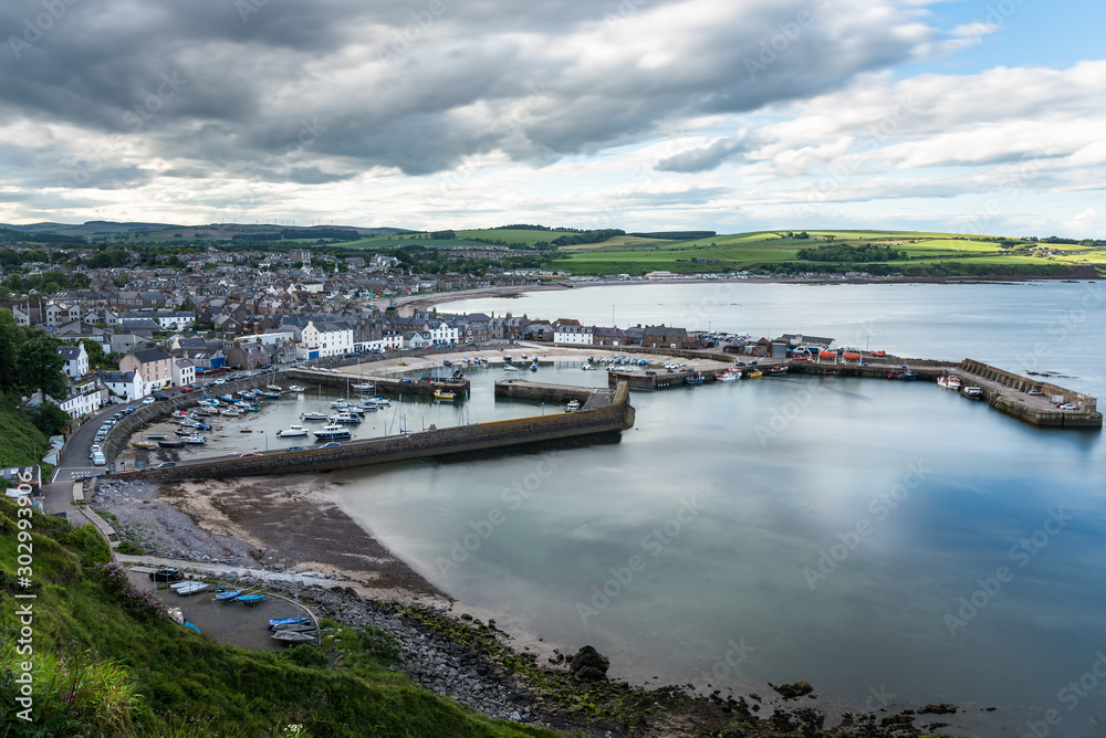 Beautiful coastal town with a harbour along the east coast of Scotland on a cloudy spring day. Stonehaven, Scotland, UK.