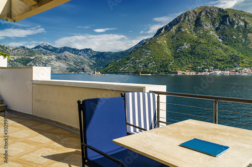 Sunny view of Boka Kotor bay from coastal cafe near Perast, Montenegro. © Neonyn