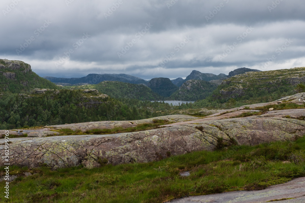 Fototapeta premium Mountains on the way to the Preachers Pulpit Rock in fjord Lysefjord - Norway - nature and travel background. Lake Tjodnane, july 2019