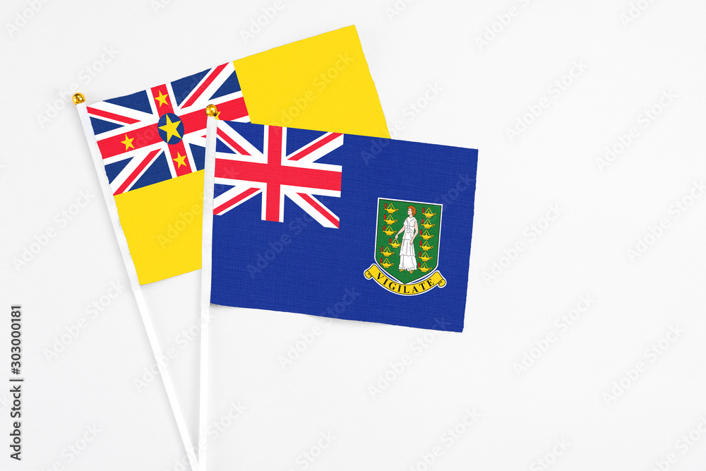 British Virgin Islands and Niue stick flags on white background. High quality fabric, miniature national flag. Peaceful global concept.White floor for copy space. British Virgin Islands and Niue stick flags on white background. High quality fabric, miniature national flag. Peaceful global concept.White floor for copy space.