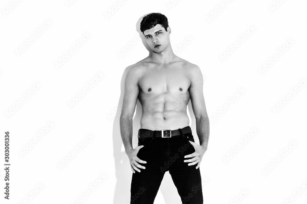 Black and White Muscle strong beautiful stripped male model in denim jeans on white isolated font background with shadow Black and White Muscle strong beautiful stripped male model in denim jeans on white isolated font background with shadow