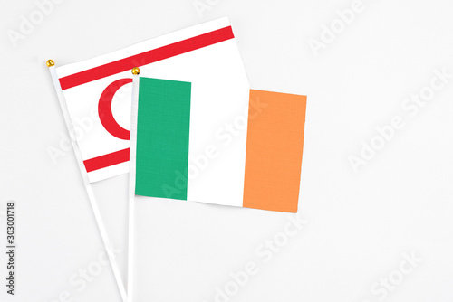 Ireland and Northern Cyprus stick flags on white background. High quality fabric, miniature national flag. Peaceful global concept.White floor for copy space.