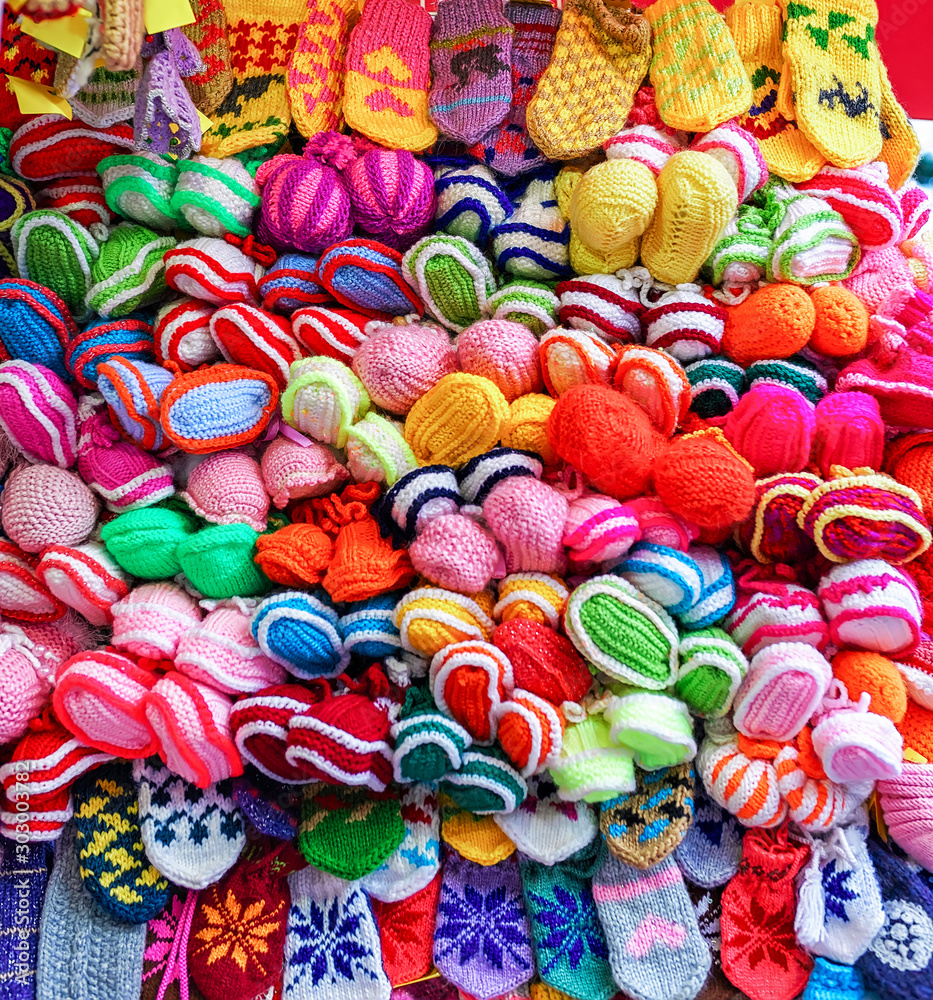 Colorful handmade socks and mittens on stalls at Christmas market in Riga of Latvia winter. Street Xmas and holiday fair in European city or town. Advent Decoration with Crafts Items on Bazaar
