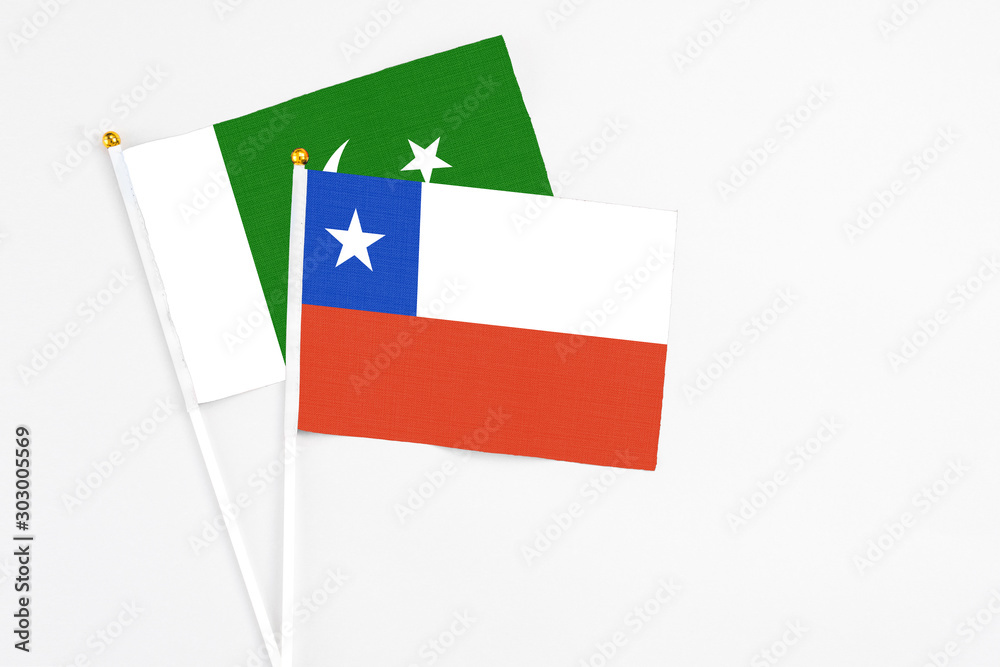 Chile and Pakistan stick flags on white background. High quality fabric, miniature national flag. Peaceful global concept.White floor for copy space. Chile and Pakistan stick flags on white background. High quality fabric, miniature national flag. Peaceful global concept.White floor for copy space.