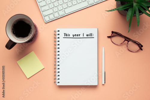 Stock photo of 2020 new year notebook with list of resolutions and objects on pink background photo
