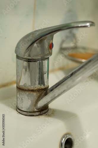 Detail of faucet with limescale or lime scale on it  dirty calcified and rusty shower mixer tap.