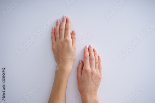 Women s hands with a nice manicure on white background.