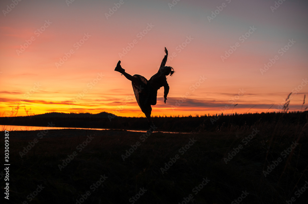 silhouette of a girl dancing on the background of a beautiful sunset