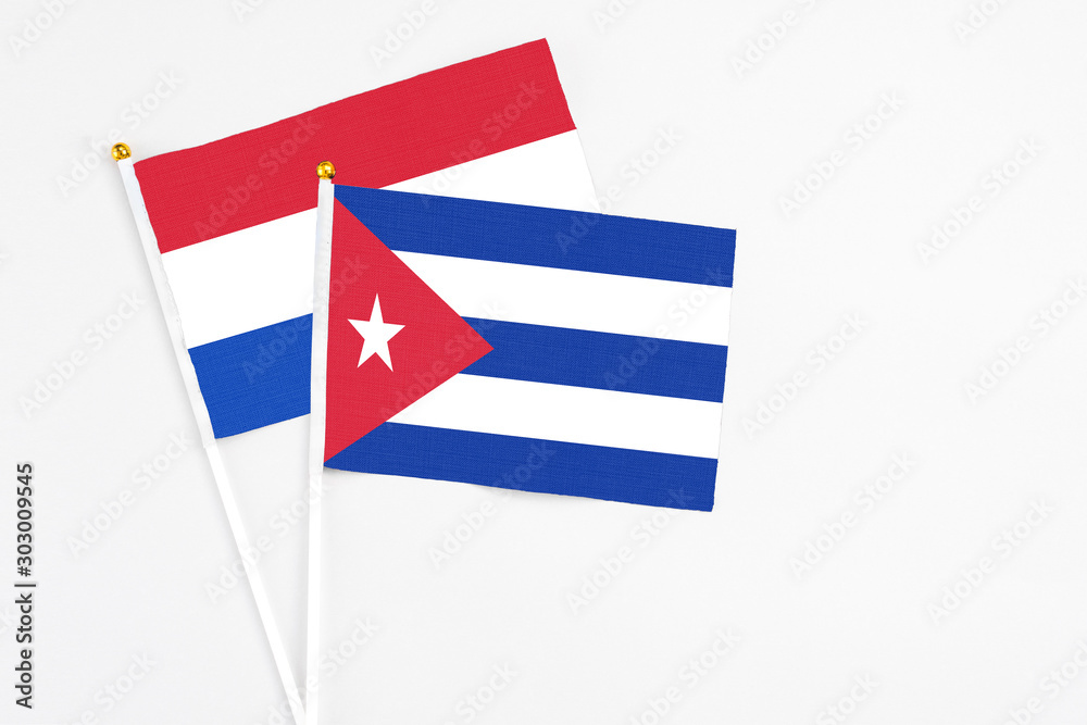 Cuba and Paraguay stick flags on white background. High quality fabric, miniature national flag. Peaceful global concept.White floor for copy space. Cuba and Paraguay stick flags on white background. High quality fabric, miniature national flag. Peaceful global concept.White floor for copy space.