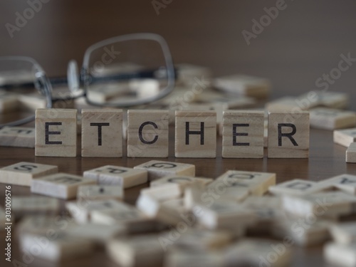 Etcher the word or concept represented by wooden letter tiles photo