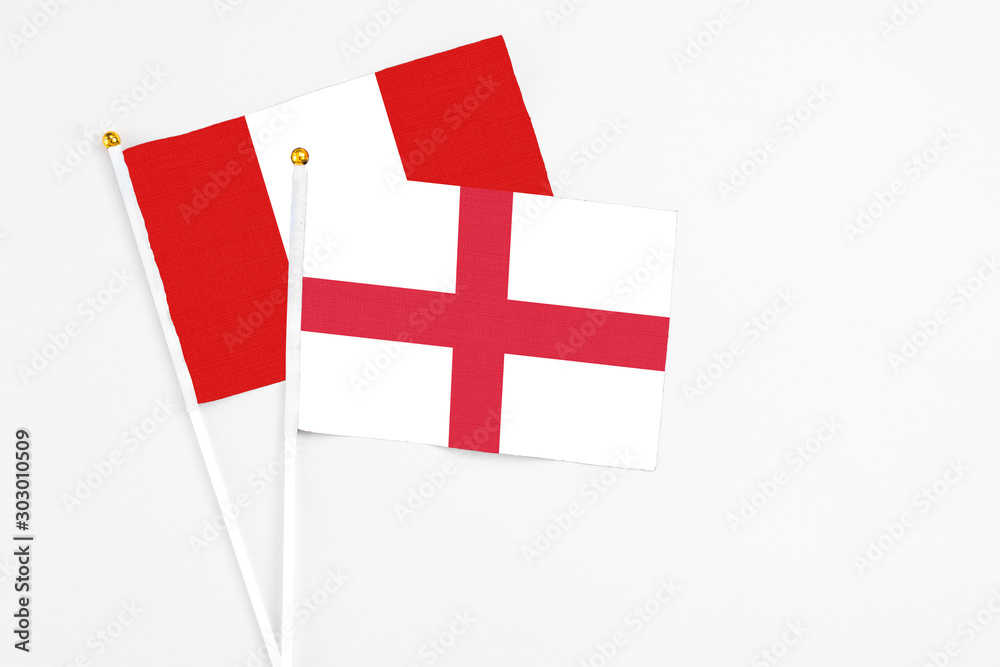 England and Peru stick flags on white background. High quality fabric, miniature national flag. Peaceful global concept.White floor for copy space.