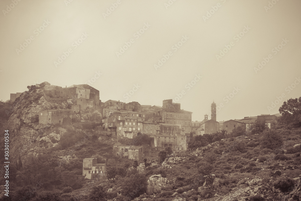 Village of Speloncato in Corsica shrouded in mist