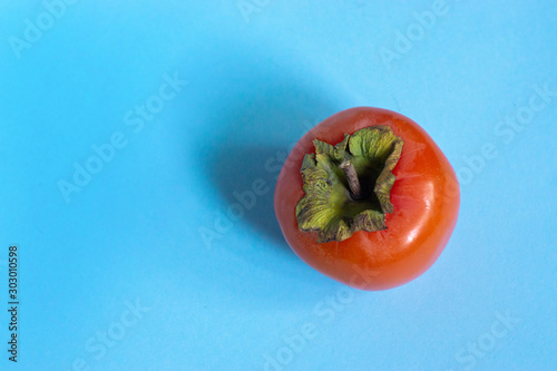 persimmon isolated on the blue background
