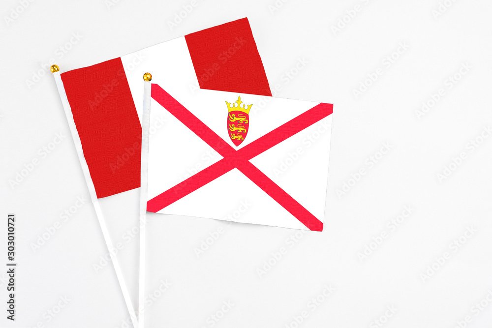 Jersey and Peru stick flags on white background. High quality fabric, miniature national flag. Peaceful global concept.White floor for copy space. Jersey and Peru stick flags on white background. High quality fabric, miniature national flag. Peaceful global concept.White floor for copy space.