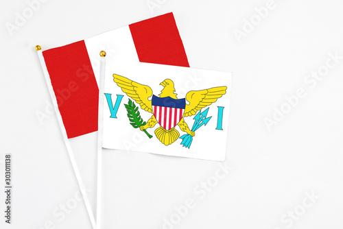 United States Virgin Islands and Peru stick flags on white background. High quality fabric, miniature national flag. Peaceful global concept.White floor for copy space.