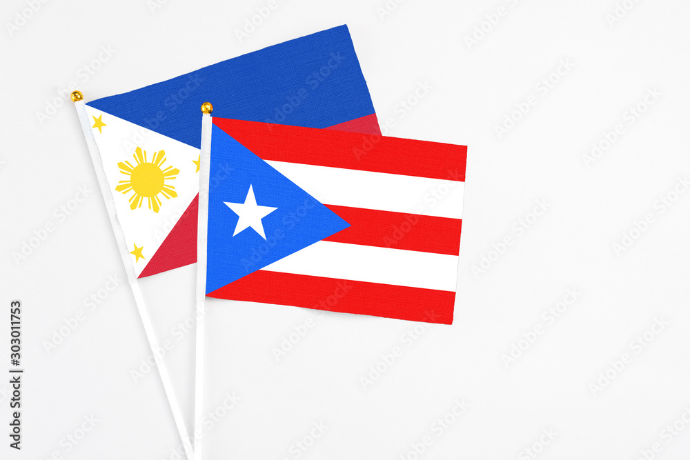 Puerto Rico and Philippines stick flags on white background. High quality fabric, miniature national flag. Peaceful global concept.White floor for copy space.