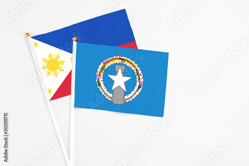 Free Download Northern Mariana Islands and Philippines stick flags on white background. High quality fabric, miniature national flag. Peaceful global concept.White floor for copy space. - GFXLoad