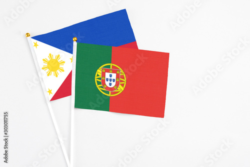 Free Download Portugal and Philippines stick flags on white background. High quality fabric, miniature national flag. Peaceful global concept.White floor for copy space. - GFXLoad
