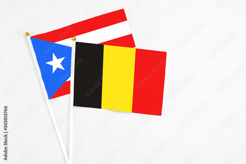 Belgium and Puerto Rico stick flags on white background. High quality fabric, miniature national flag. Peaceful global concept.White floor for copy space. Belgium and Puerto Rico stick flags on white background. High quality fabric, miniature national flag. Peaceful global concept.White floor for copy space.