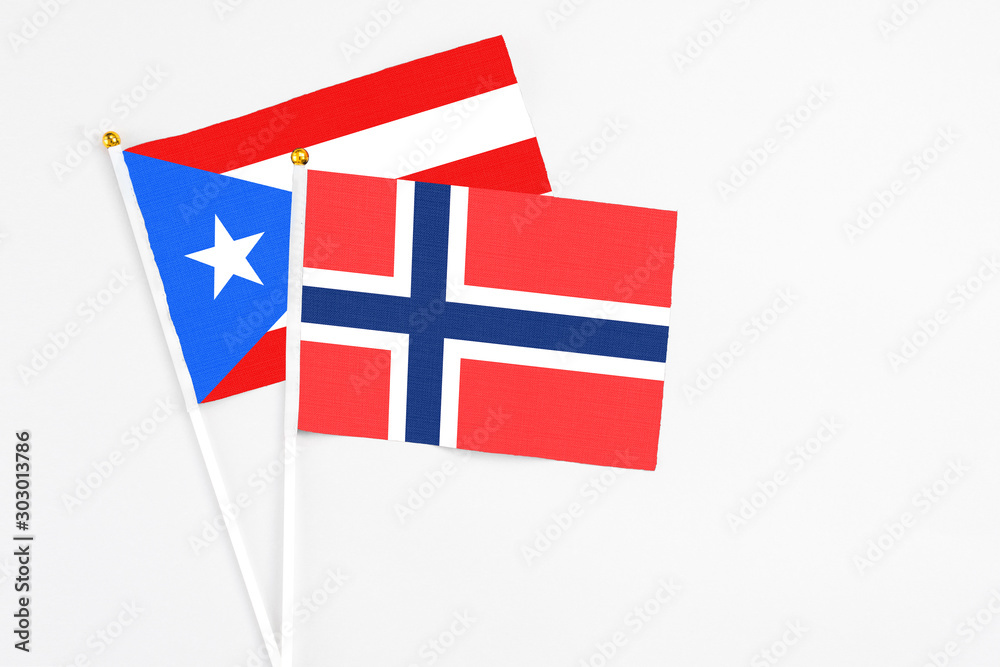 Bouvet Islands and Puerto Rico stick flags on white background. High quality fabric, miniature national flag. Peaceful global concept.White floor for copy space. Bouvet Islands and Puerto Rico stick flags on white background. High quality fabric, miniature national flag. Peaceful global concept.White floor for copy space.