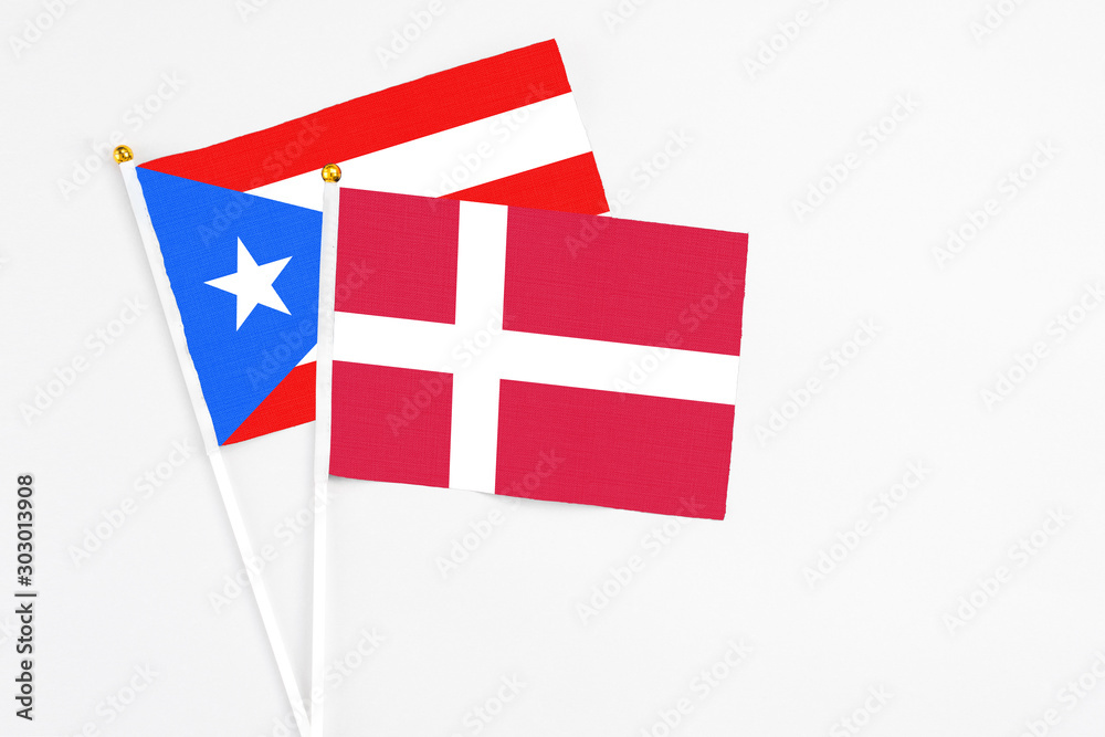 Denmark and Puerto Rico stick flags on white background. High quality fabric, miniature national flag. Peaceful global concept.White floor for copy space.