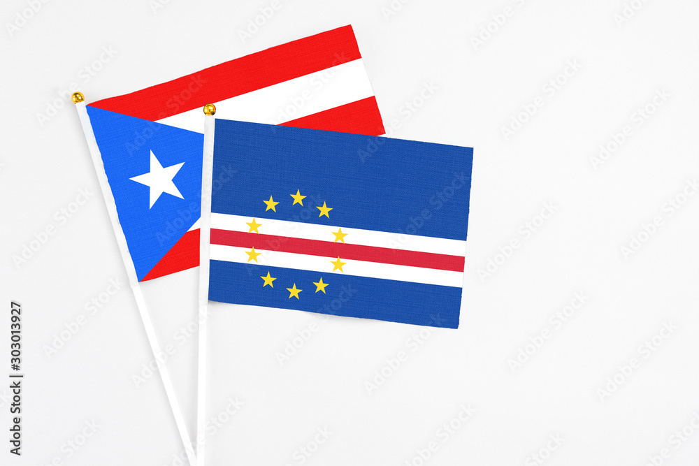 Cape Verde and Puerto Rico stick flags on white background. High quality fabric, miniature national flag. Peaceful global concept.White floor for copy space. Cape Verde and Puerto Rico stick flags on white background. High quality fabric, miniature national flag. Peaceful global concept.White floor for copy space.