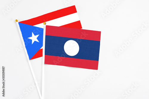 Free Download Laos and Puerto Rico stick flags on white background. High quality fabric, miniature national flag. Peaceful global concept.White floor for copy space. - GFXLoad