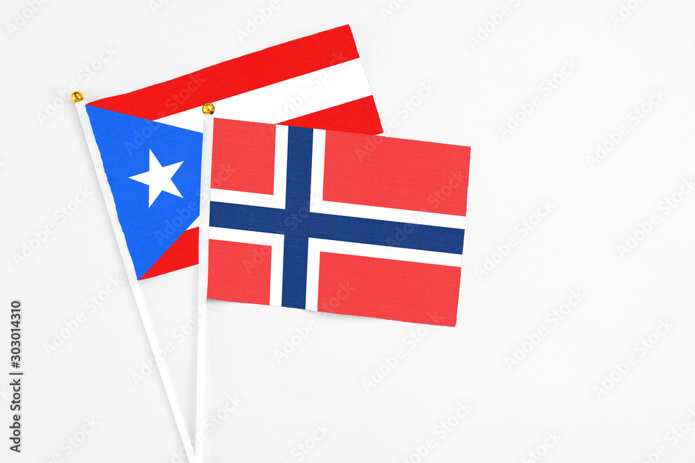Norway and Puerto Rico stick flags on white background. High quality fabric, miniature national flag. Peaceful global concept.White floor for copy space. Norway and Puerto Rico stick flags on white background. High quality fabric, miniature national flag. Peaceful global concept.White floor for copy space.