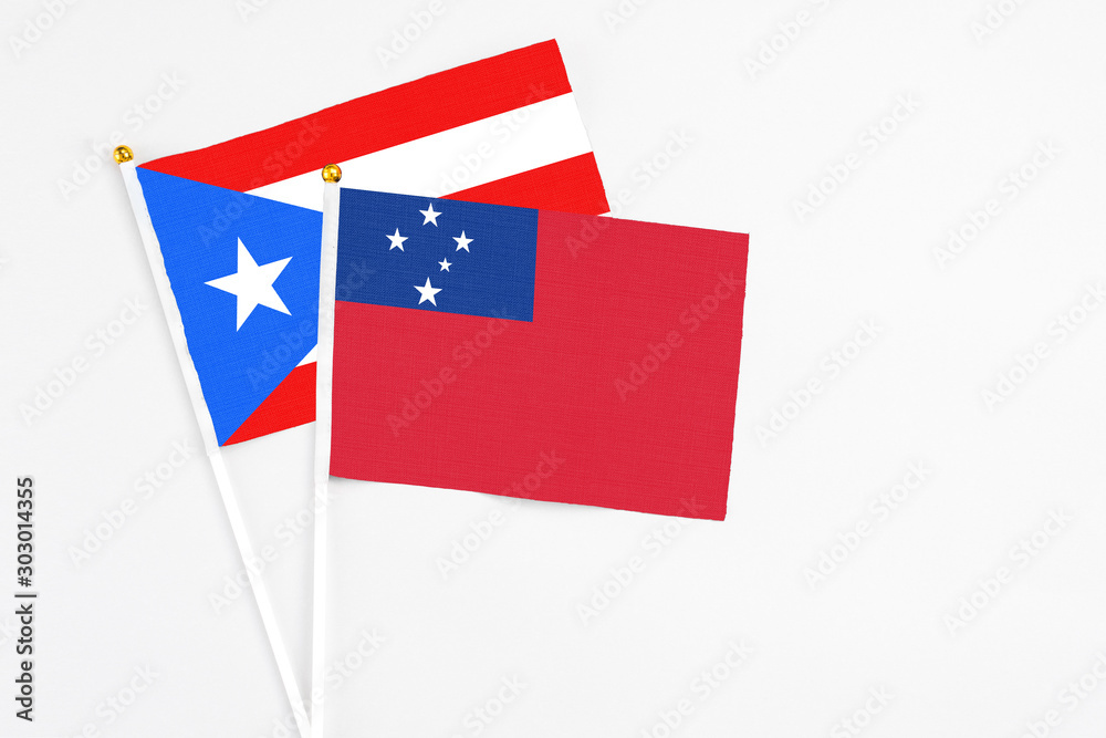 Samoa and Puerto Rico stick flags on white background. High quality fabric, miniature national flag. Peaceful global concept.White floor for copy space.