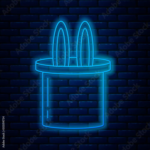 Glowing neon line Magician hat and rabbit ears icon isolated on brick wall background. Magic trick. Mystery entertainment concept. Vector Illustration