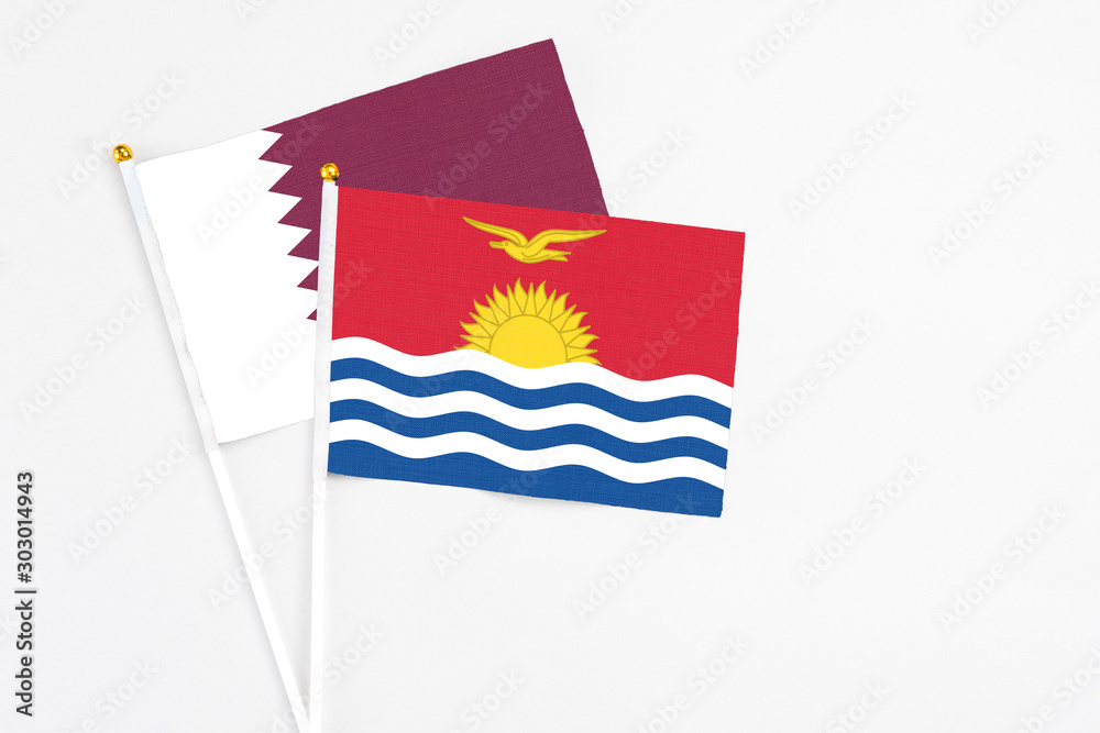 Kiribati and Qatar stick flags on white background. High quality fabric, miniature national flag. Peaceful global concept.White floor for copy space. Kiribati and Qatar stick flags on white background. High quality fabric, miniature national flag. Peaceful global concept.White floor for copy space.