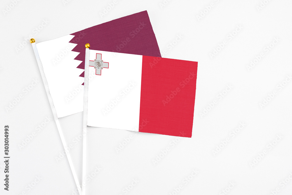 Malta and Qatar stick flags on white background. High quality fabric, miniature national flag. Peaceful global concept.White floor for copy space. Malta and Qatar stick flags on white background. High quality fabric, miniature national flag. Peaceful global concept.White floor for copy space.