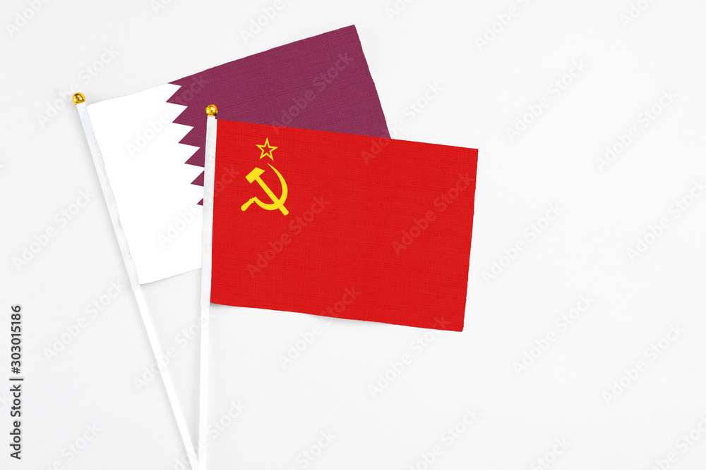 Soviet Union and Qatar stick flags on white background. High quality fabric, miniature national flag. Peaceful global concept.White floor for copy space.