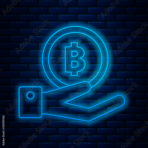 Glowing neon line Hand holding Bitcoin icon isolated on brick wall background. Blockchain technology, digital money market, cryptocoin wallet. Vector Illustration