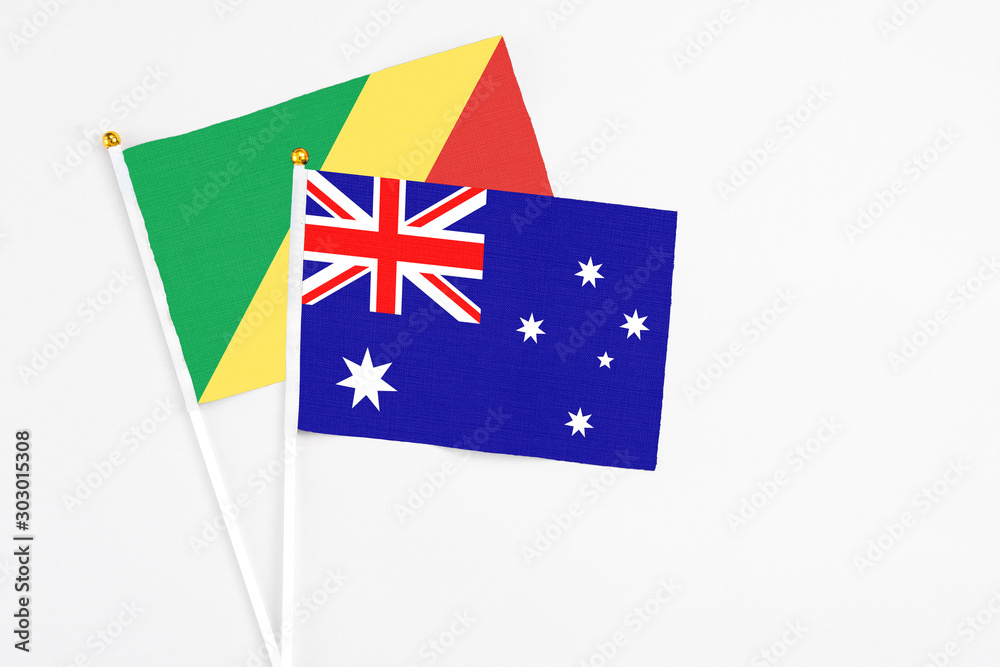 Fototapeta premium Australia and Republic Of The Congo stick flags on white background. High quality fabric, miniature national flag. Peaceful global concept.White floor for copy space.