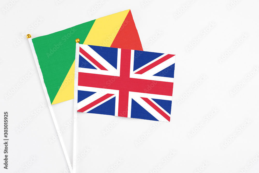 United Kingdom and Republic Of The Congo stick flags on white background. High quality fabric, miniature national flag. Peaceful global concept.White floor for copy space. United Kingdom and Republic Of The Congo stick flags on white background. High quality fabric, miniature national flag. Peaceful global concept.White floor for copy space.