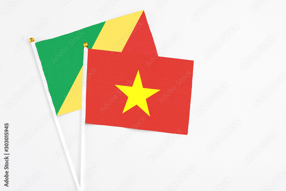 Vietnam and Republic Of The Congo stick flags on white background. High quality fabric, miniature national flag. Peaceful global concept.White floor for copy space. Vietnam and Republic Of The Congo stick flags on white background. High quality fabric, miniature national flag. Peaceful global concept.White floor for copy space.