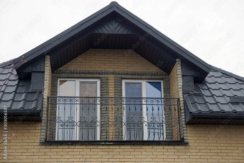 open black iron balcony on the brown brick wall of a private house open black iron balcony on the brown brick wall of a private house