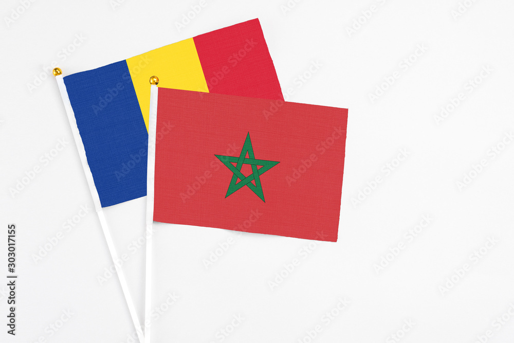 Morocco and Romania stick flags on white background. High quality fabric, miniature national flag. Peaceful global concept.White floor for copy space. Morocco and Romania stick flags on white background. High quality fabric, miniature national flag. Peaceful global concept.White floor for copy space.