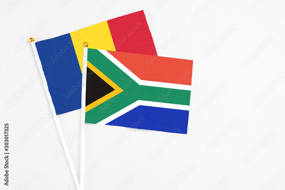 Fototapeta premium South Africa and Romania stick flags on white background. High quality fabric, miniature national flag. Peaceful global concept.White floor for copy space.