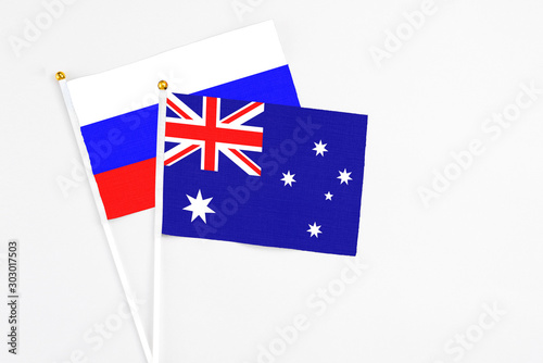 Australia and Russia stick flags on white background. High quality fabric, miniature national flag. Peaceful global concept.White floor for copy space. photo