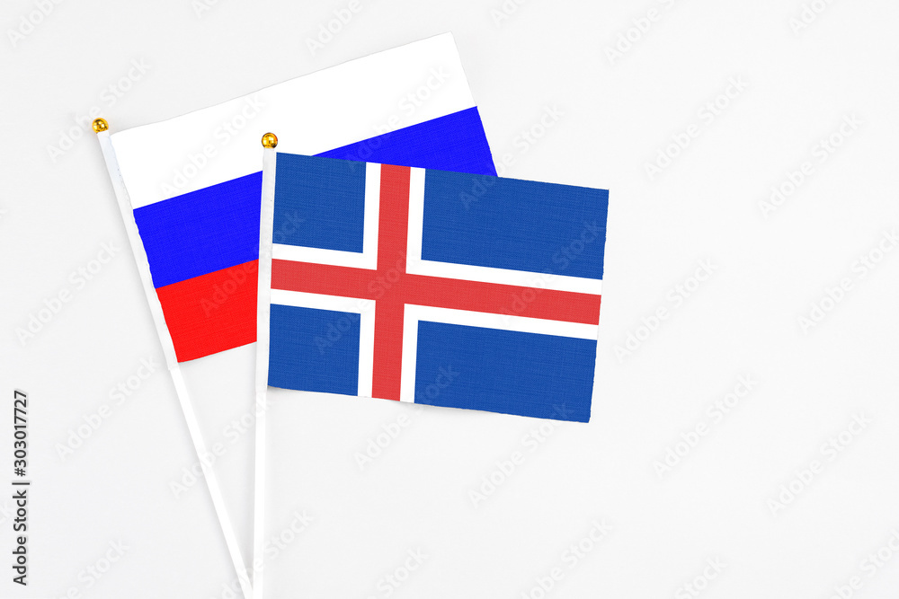 Iceland and Russia stick flags on white background. High quality fabric, miniature national flag. Peaceful global concept.White floor for copy space. Iceland and Russia stick flags on white background. High quality fabric, miniature national flag. Peaceful global concept.White floor for copy space.