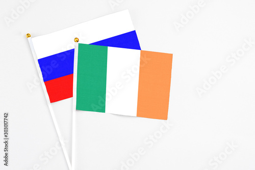 Free Download Ireland and Russia stick flags on white background. High quality fabric, miniature national flag. Peaceful global concept.White floor for copy space. - GFXLoad