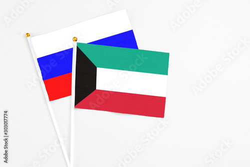 Free Download Kuwait and Russia stick flags on white background. High quality fabric, miniature national flag. Peaceful global concept.White floor for copy space. - GFXLoad