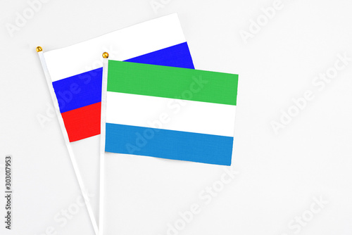 Free Download Sierra Leone and Russia stick flags on white background. High quality fabric, miniature national flag. Peaceful global concept.White floor for copy space. - GFXLoad