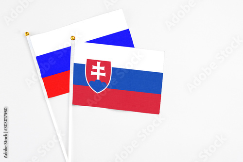 Free Download Slovakia and Russia stick flags on white background. High quality fabric, miniature national flag. Peaceful global concept.White floor for copy space. - GFXLoad